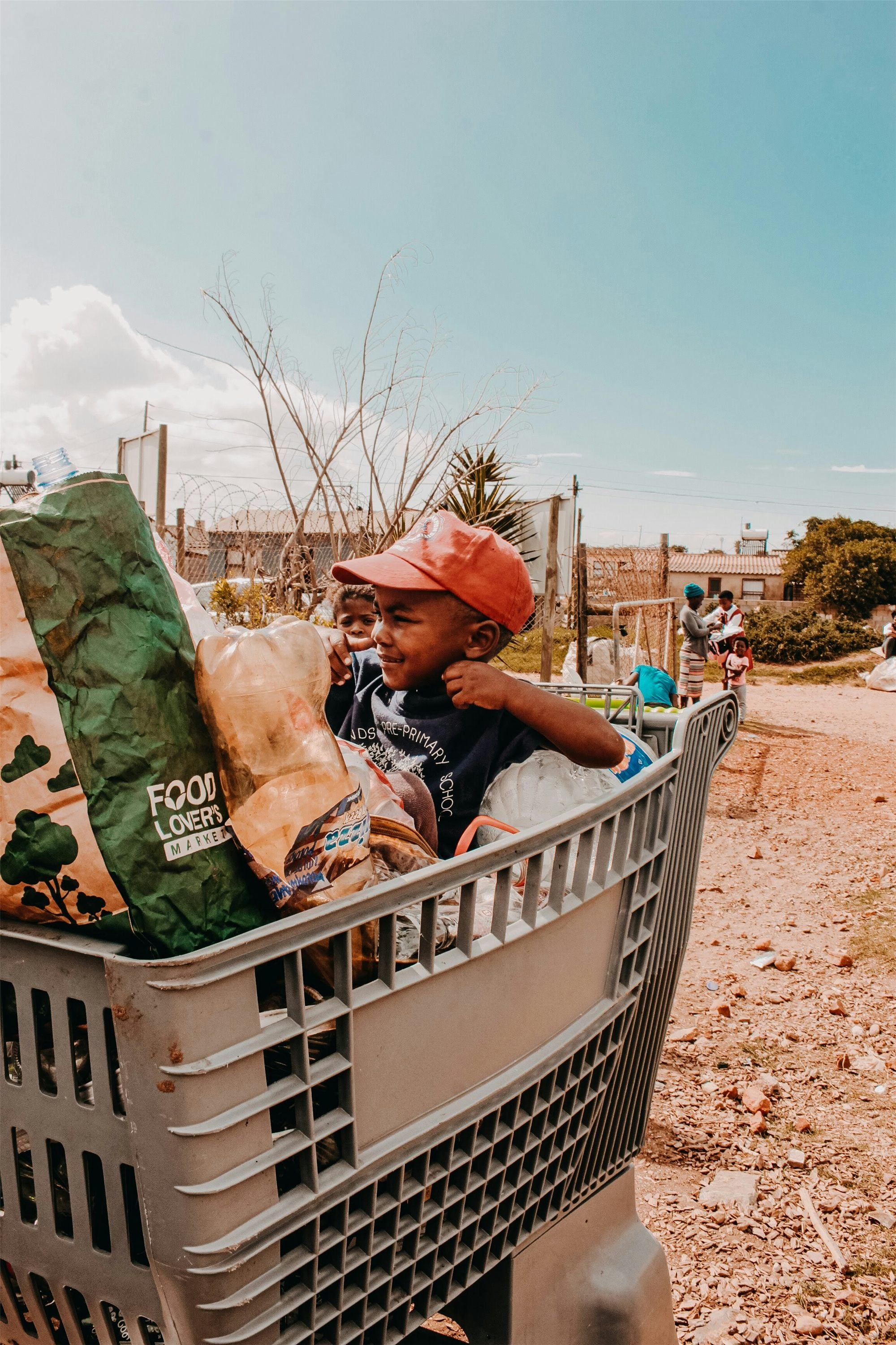 Children playing outside with food packaging